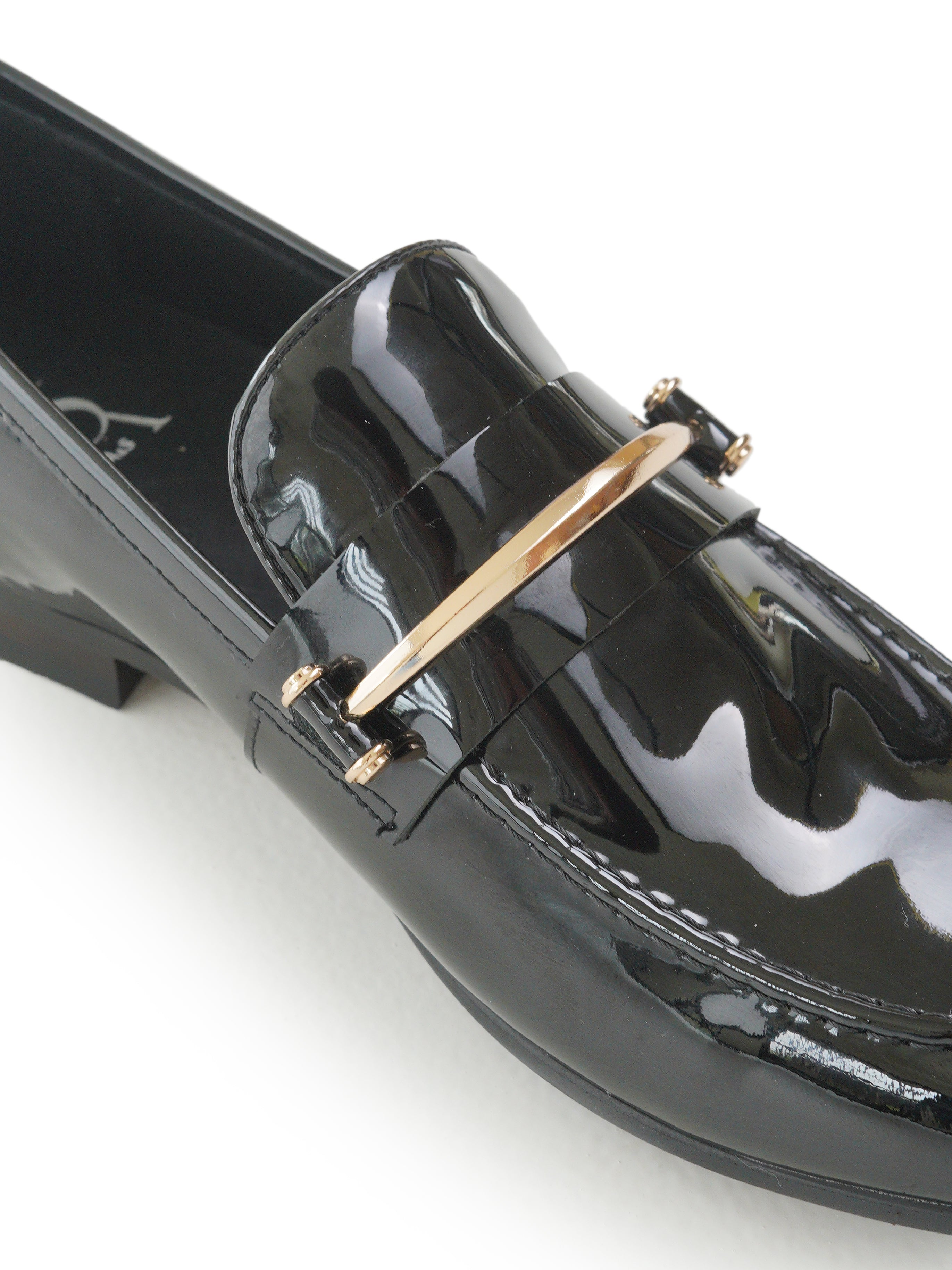 Patent mocassins with gold hardware